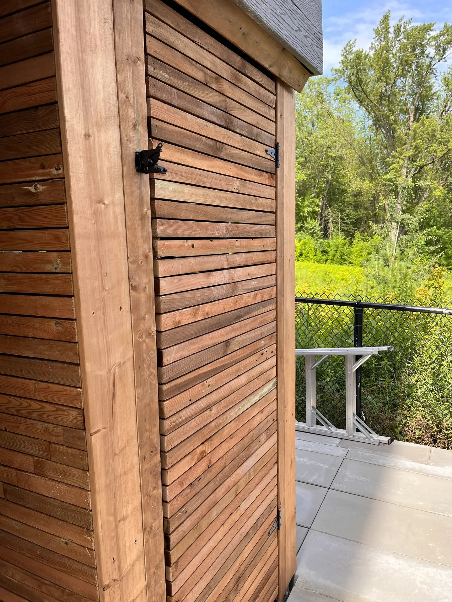 Horizontal wood privacy screen beside an exterior landing