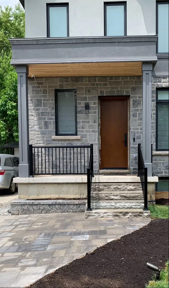 Front entry steps with black metal handrail