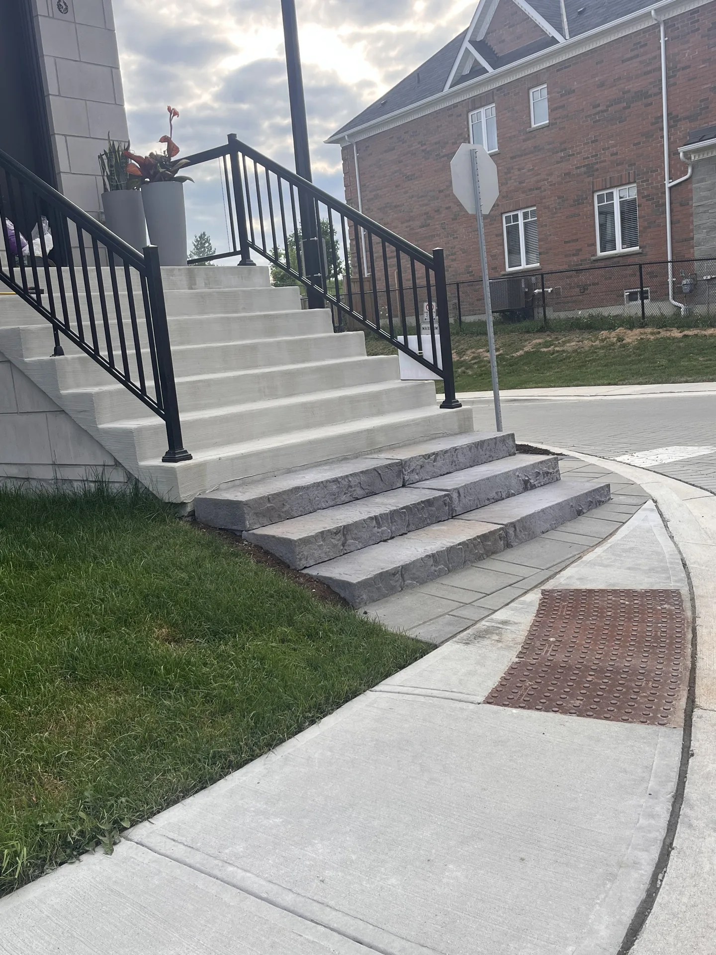 Black exterior railing along front concrete steps