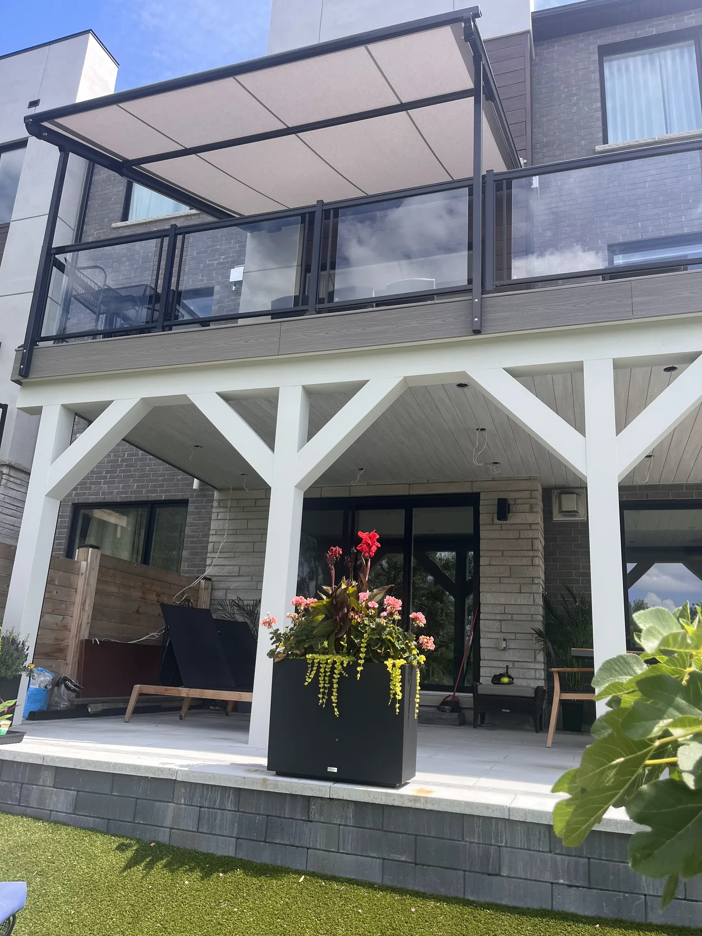 Elevated deck with black framed glass-panel railing
